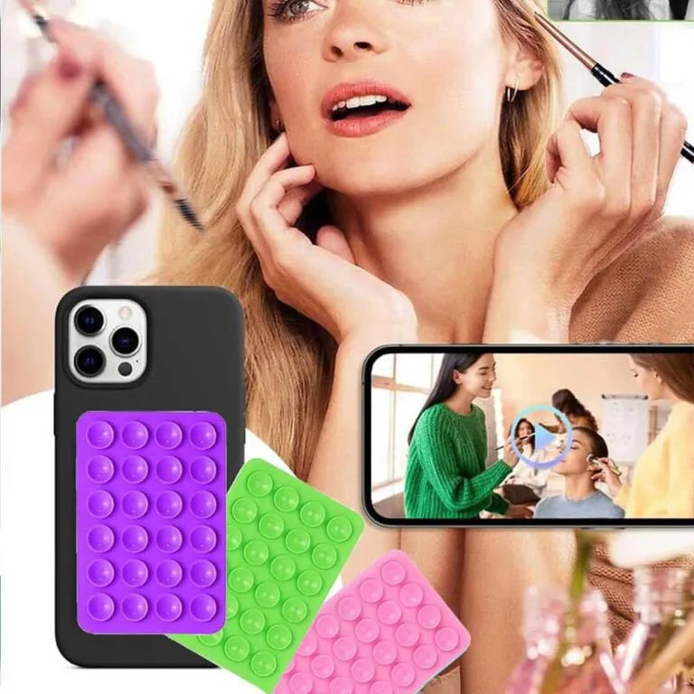 Sticky pod holding phone on mirror for selfies